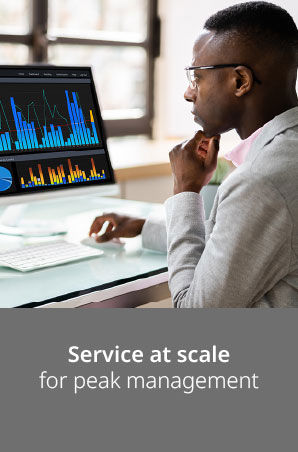 Serious man working on computer with his hand on his chin