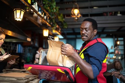 Delivery person delivering meal