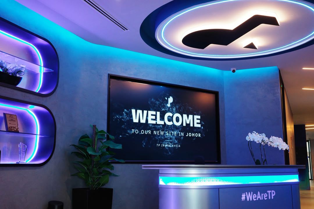 Modern lit TP Johor office reception with welcome display screen.