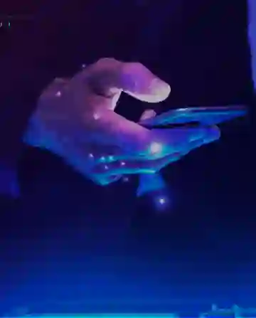 Person holding a smartphone with futuristic digital interface, glowing in blue and purple tones.
