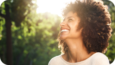 Young girl smiling with trees on the background 