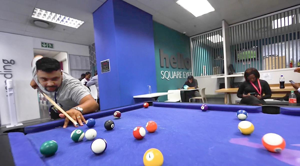African employee playing pool