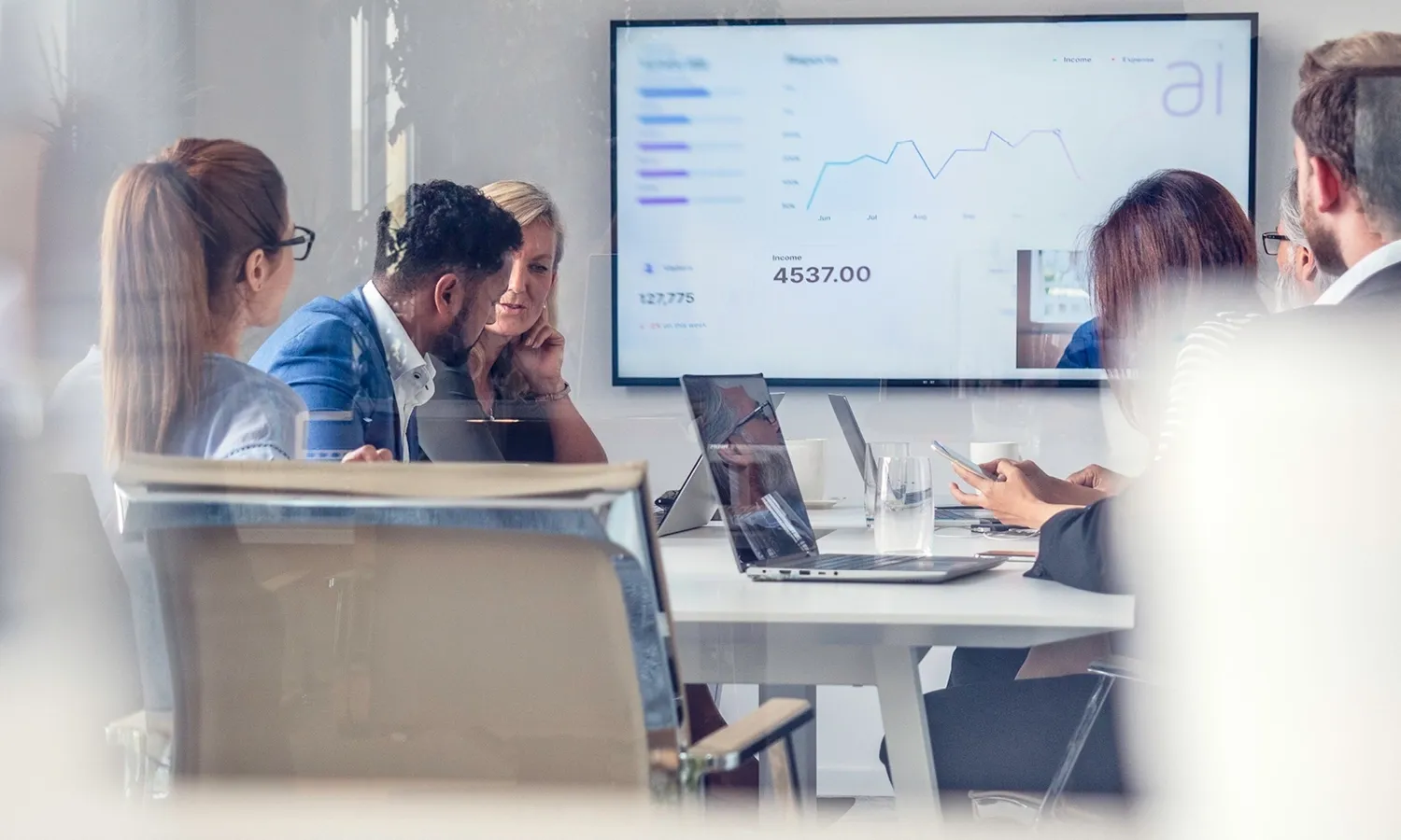 Team reviewing analytics dashboard during a business meeting.