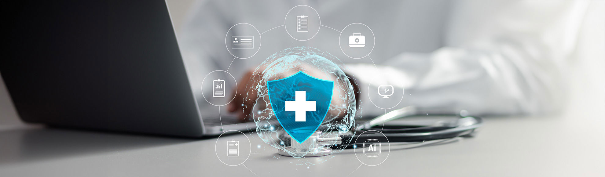 Digital healthcare security illustration showing a glowing shield with a medical cross over a transparent globe, surrounded by healthcare and technology icons on a desk with a laptop and stethoscope.