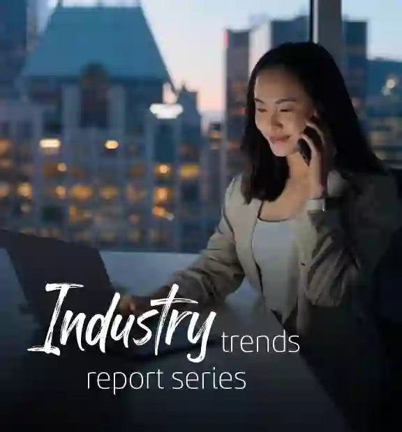 Asian business woman working on her laptop while talk in the phone in a modern office space