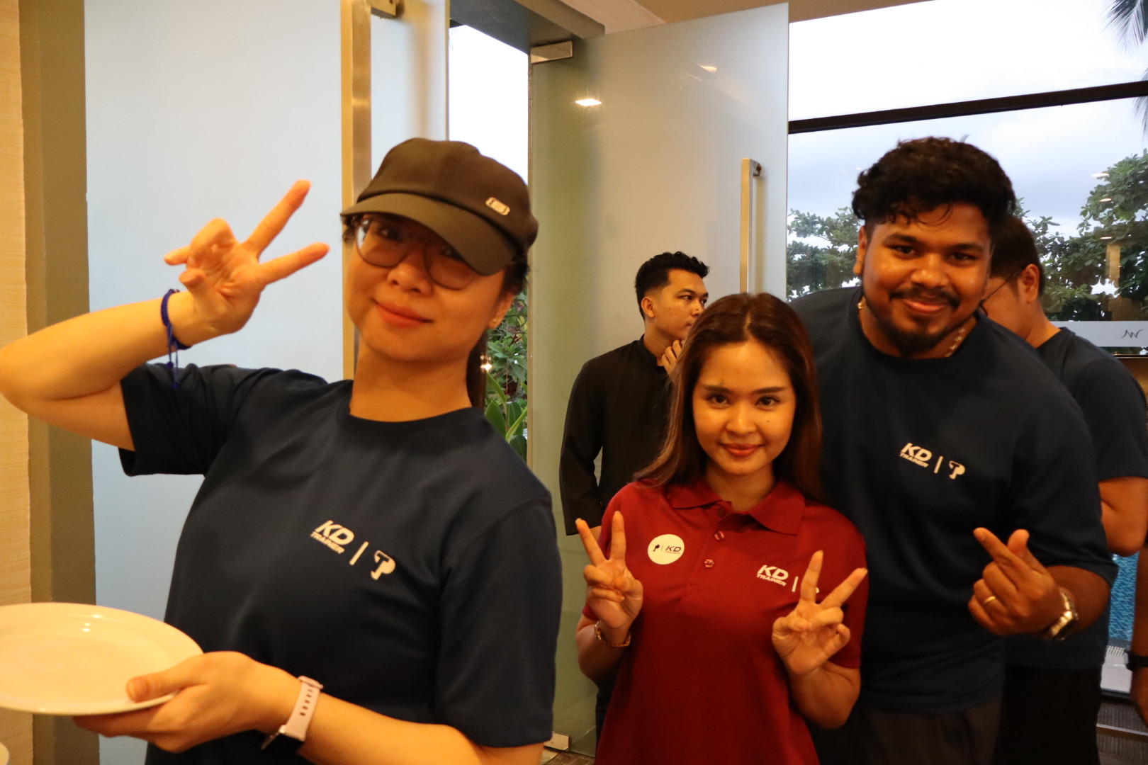 TP employees smiling and making peace signs at company event