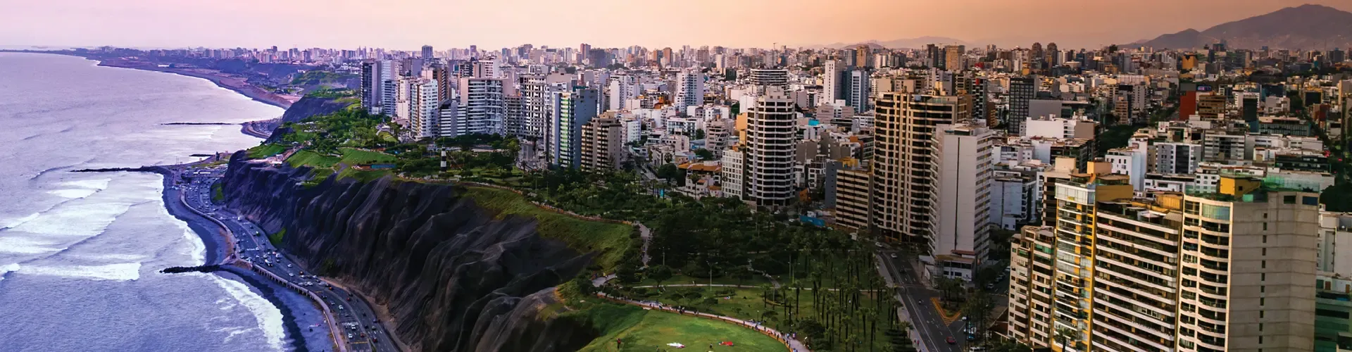 Lima cityscape along the Pacific coast with cliffs, parks, and high-rise buildings.