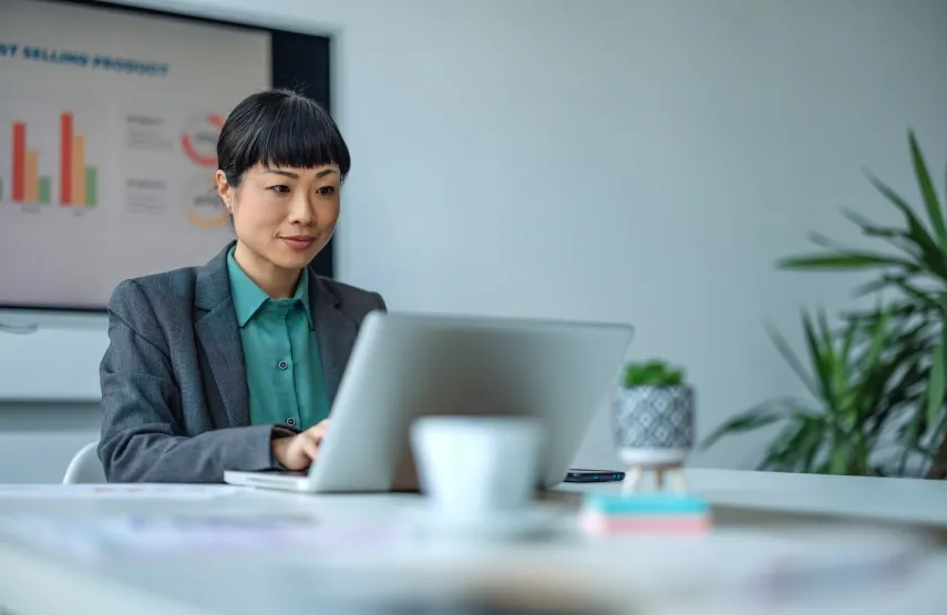 Asian business professional focused while working in an office.