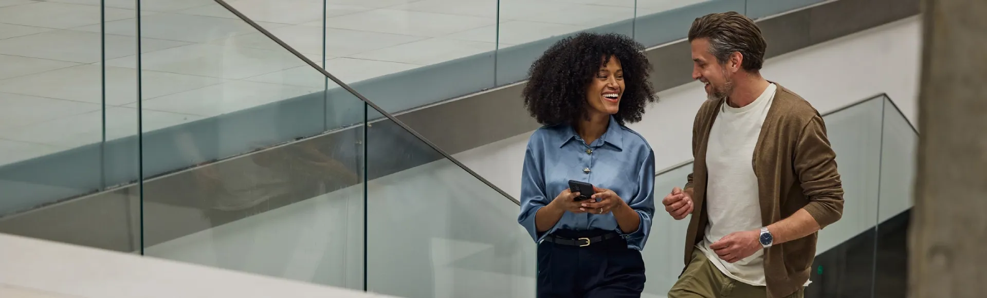 Business colleagues walking up the stairs of a commercial building together.