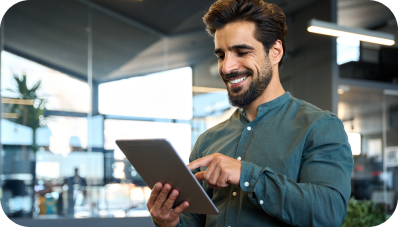 Smiling man holding a tablet st the office