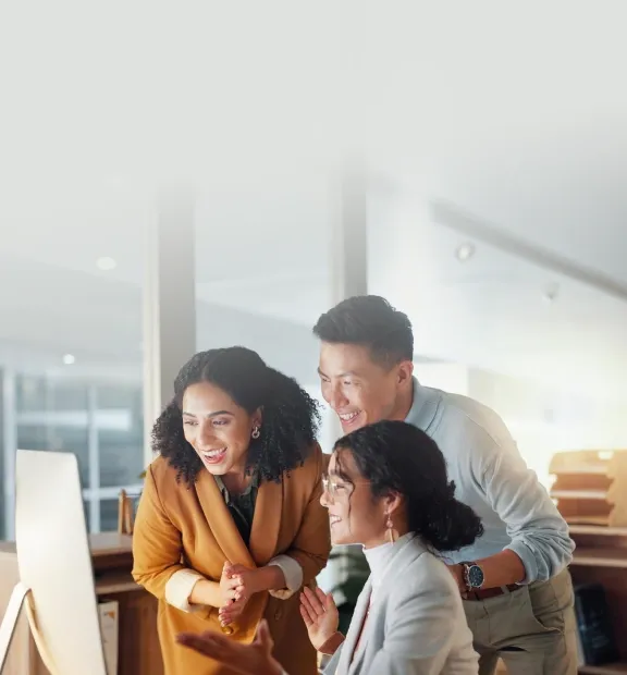 A diverse and cheerful business team celebrates a successful win together in a modern office, sharing joy and applause.