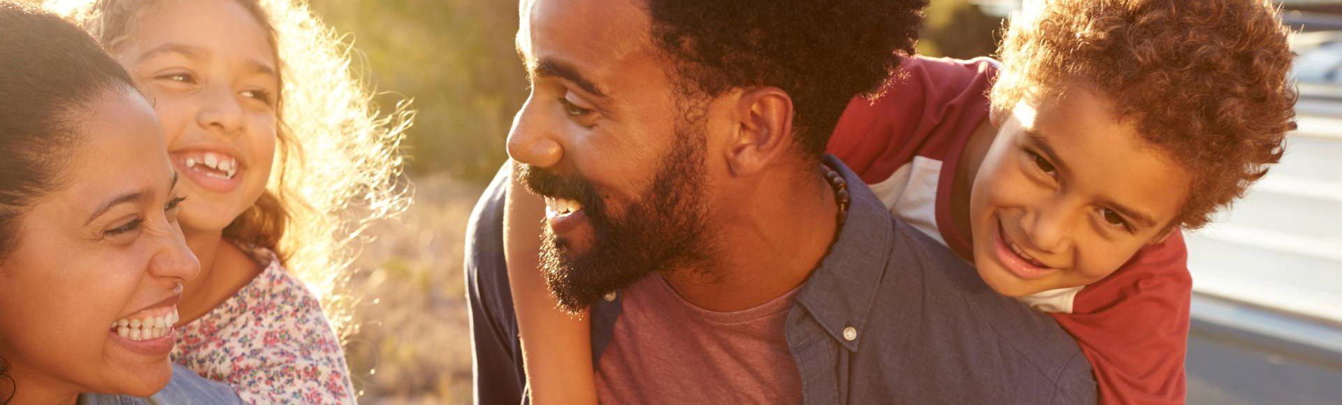 Happy African family enjoying time together outdoors on a bright sunny day.