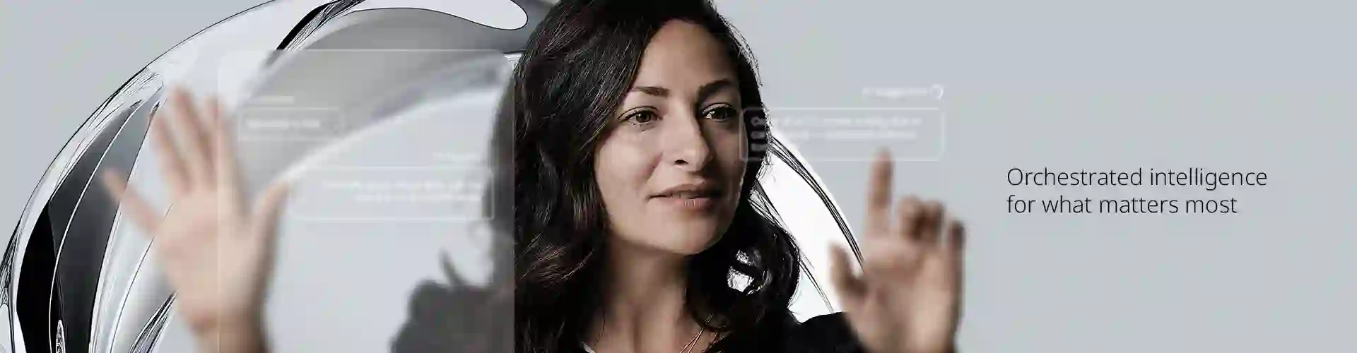 Woman interacting with transparent digital interface displaying AI-generated customer support suggestions, with the text 'Orchestrated intelligence for what matters the most' in the background.
