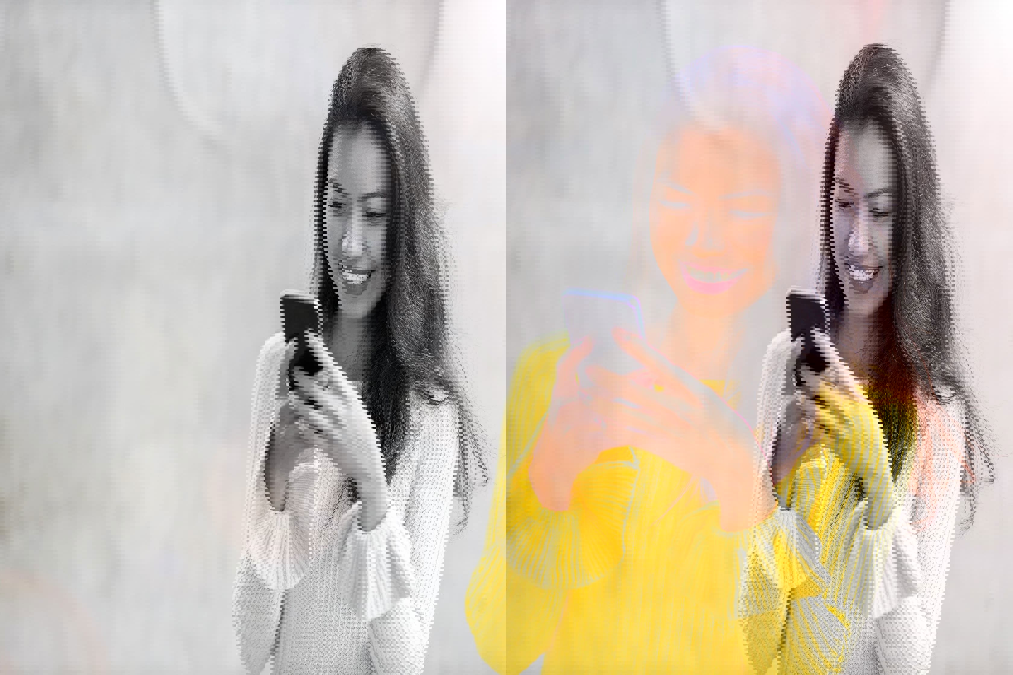 Young smiling asian girl browshing her cellphone