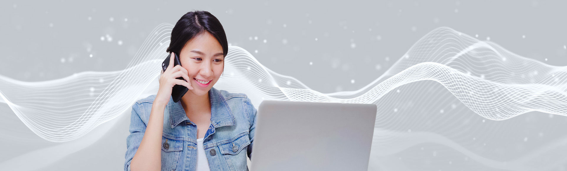 Smiling lady talks on phone while checking laptop amid digital sound waves.