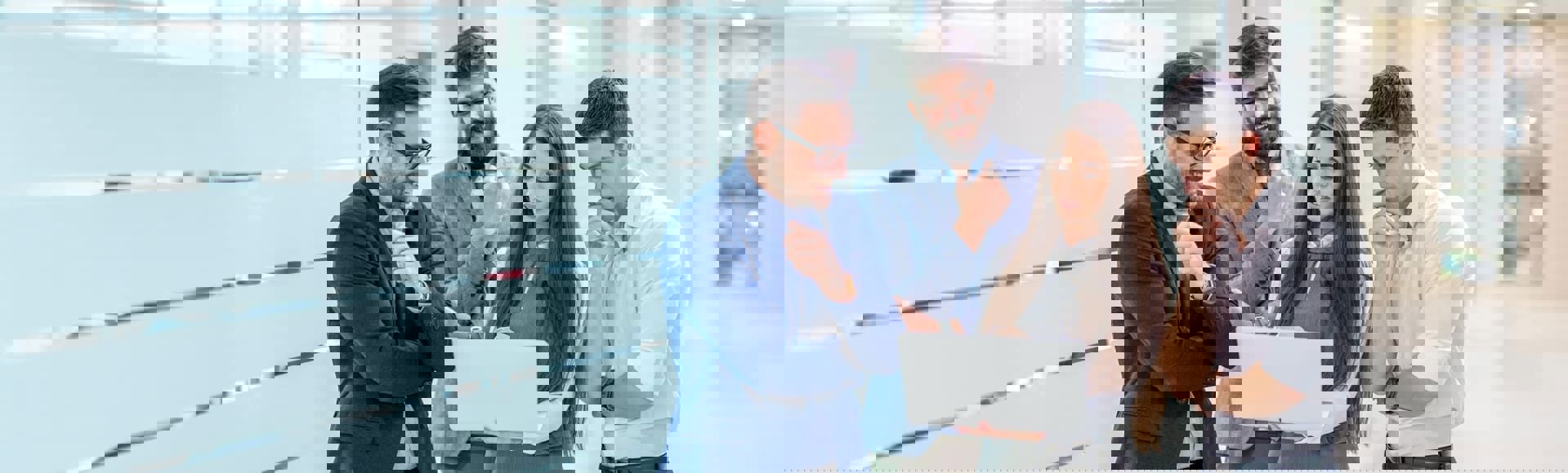 Team of employees collaborating in an office, representing late-stage debt recovery strategies.