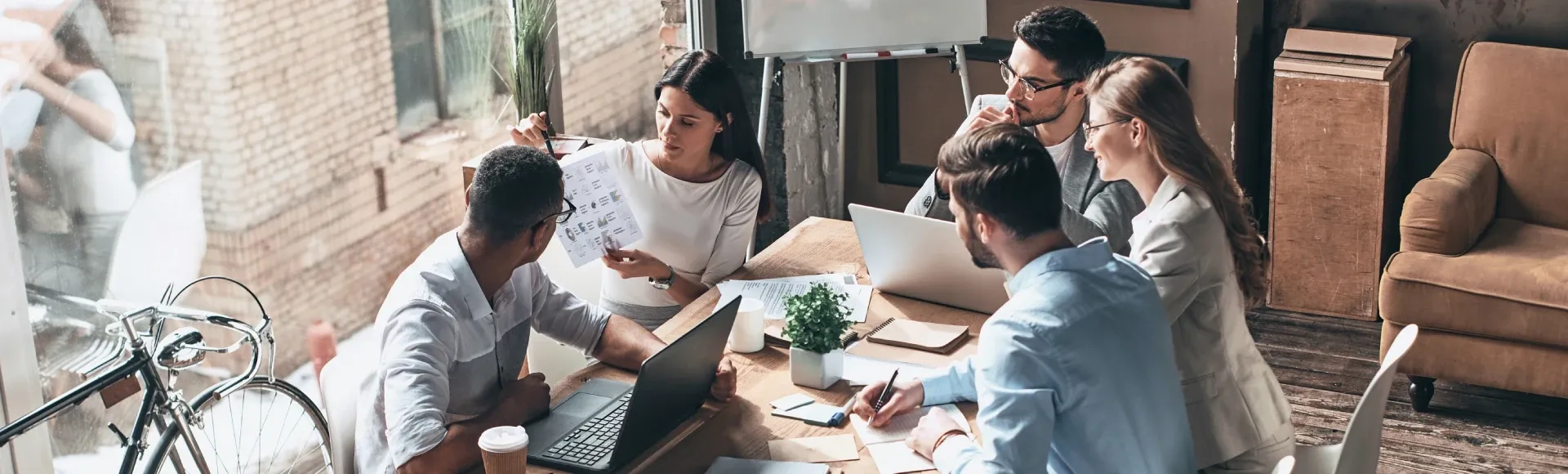 Colleagues gathered around a table during a business meeting.