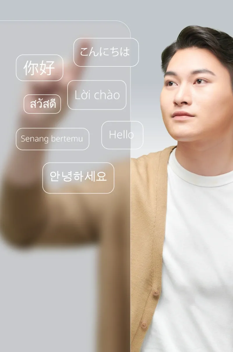 Asian young man interacting with a 3D multilingual interface, symbolizing global connection.