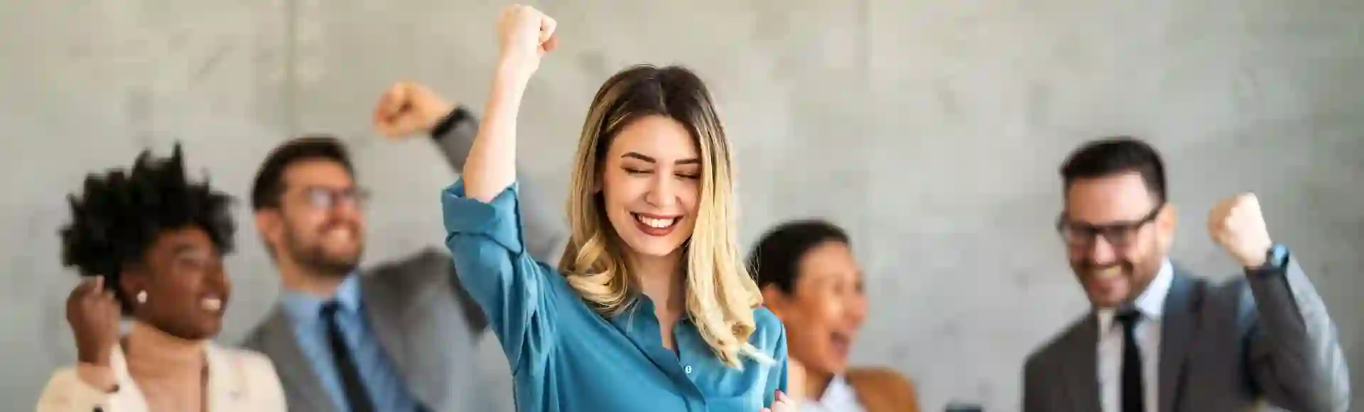 Diverse team celebrating a collective achievement in the workplace.
