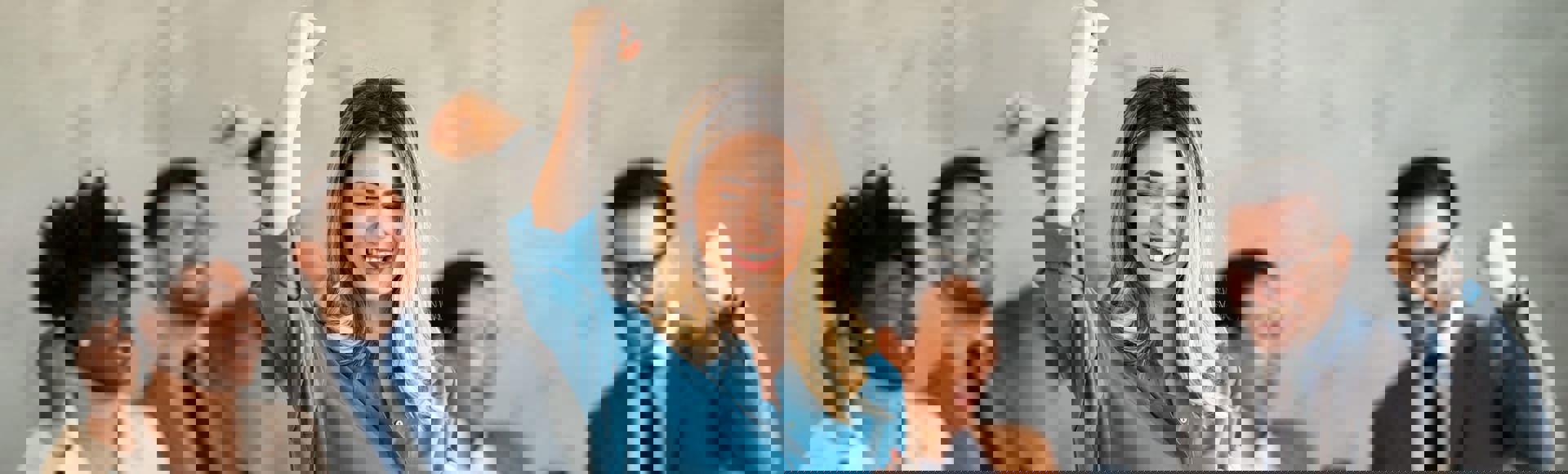 Diverse team celebrating a collective achievement in the workplace.