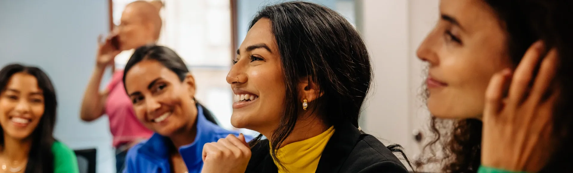 Close up of a smiling professional in an office setting.