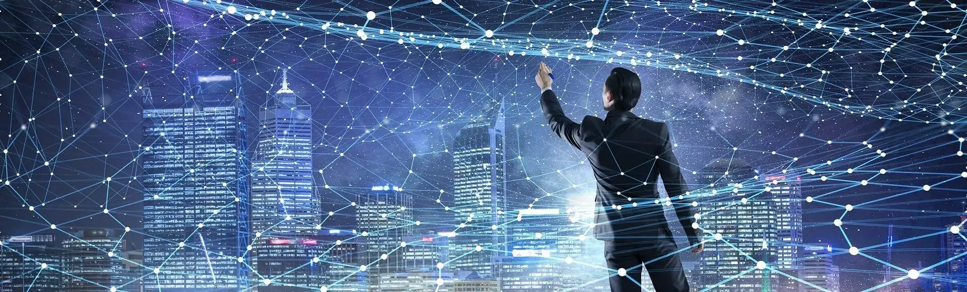 Man interacting with a digital network overlay above a city skyline.