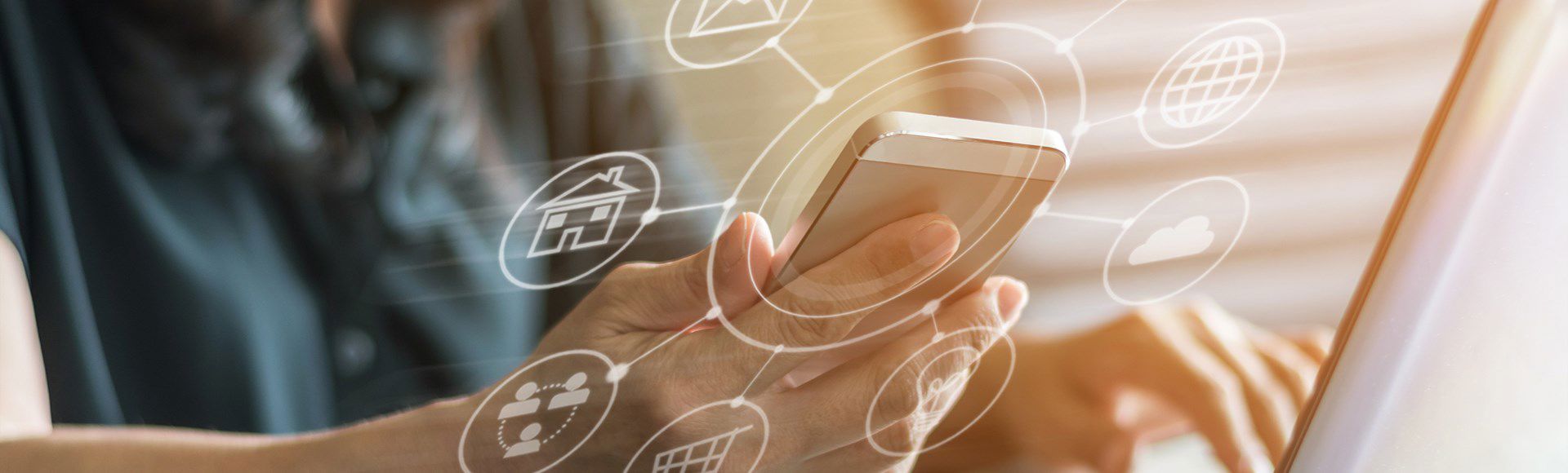 Person holding a smartphone with futuristic 3D icons symbolizing digital innovation.