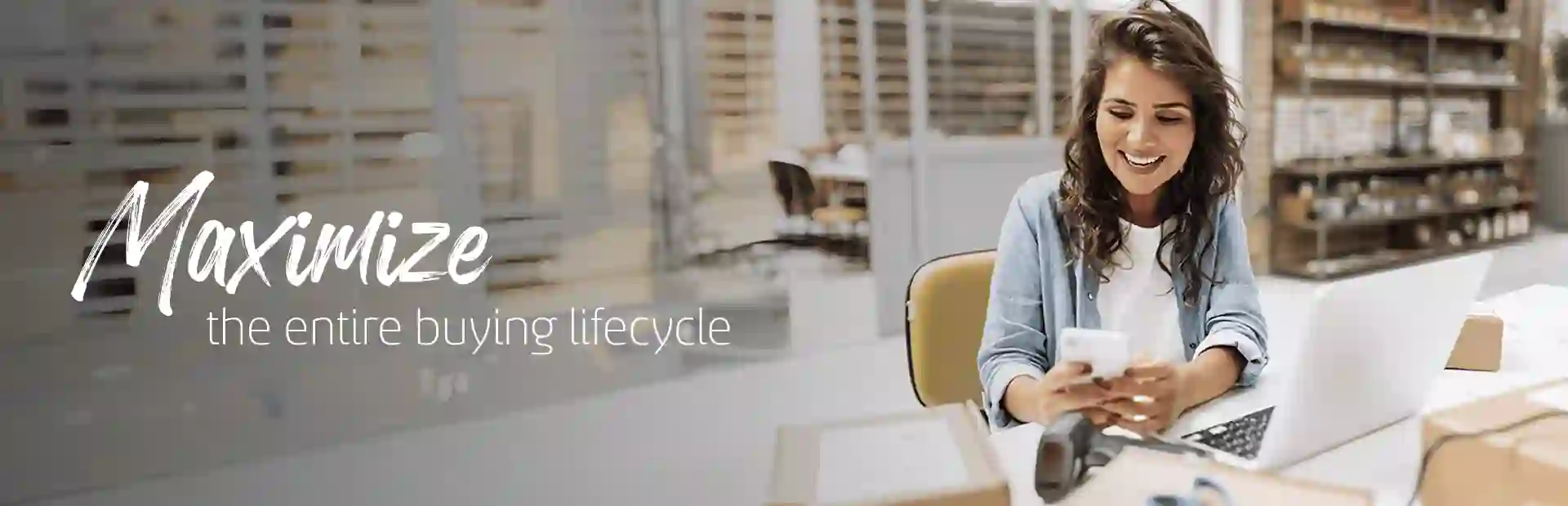 Woman smiling while looking at her phone at the office