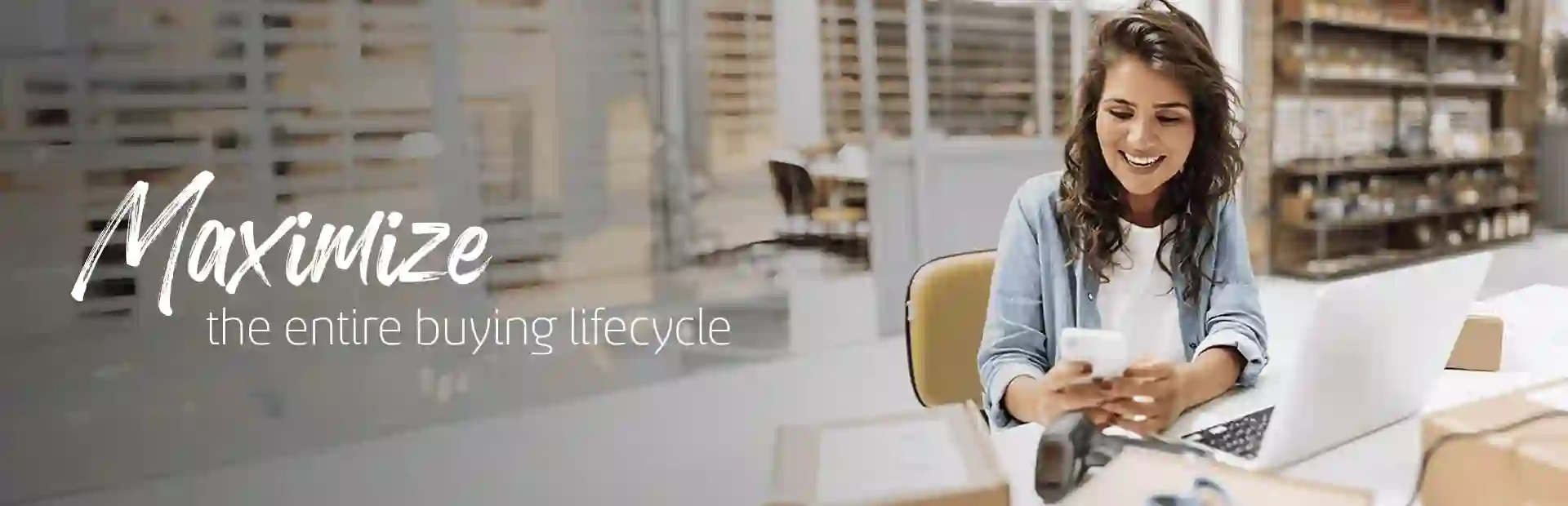 Woman smiling while looking at her phone at the office
