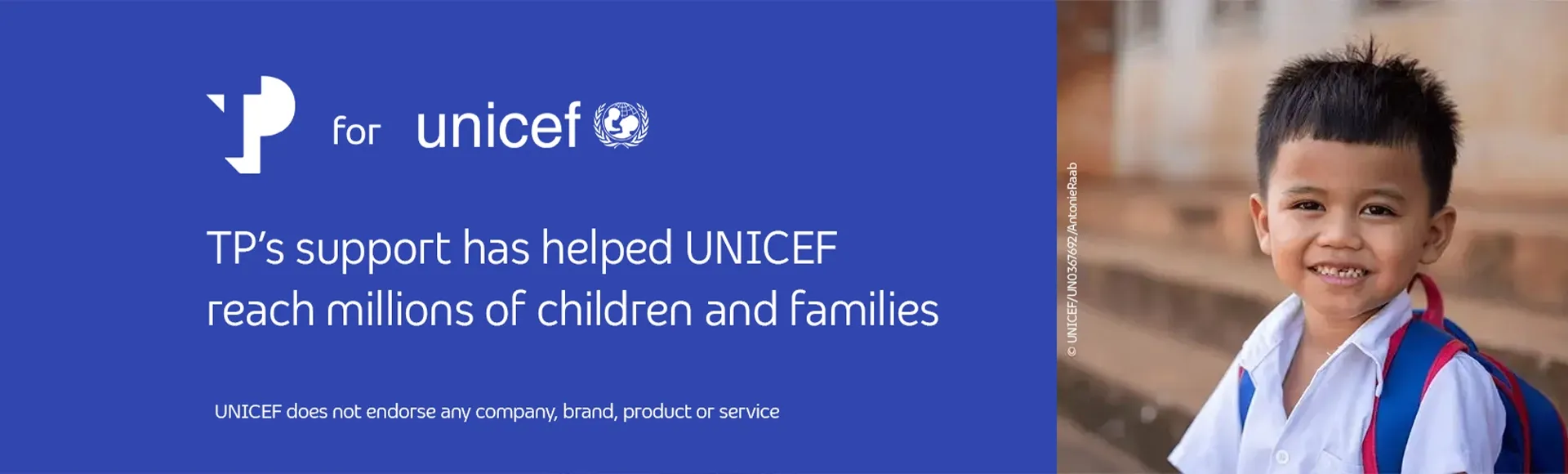 Smiling young boy, next to a blue UNICEF banner with the message supporting a brighter tomorrow.