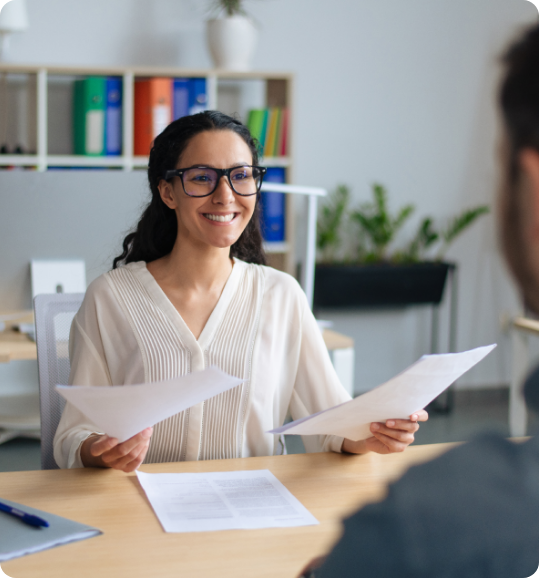 Insurance professional conducting a client meeting or interview, representing smart outsourcing solutions in a modern office setting.