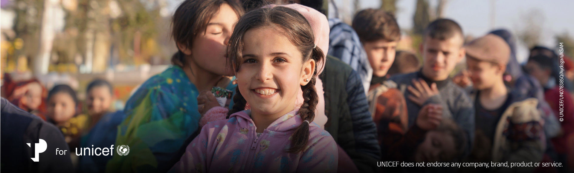 Smiling young girl representing hope in TP for UNICEF earthquake recovery efforts.