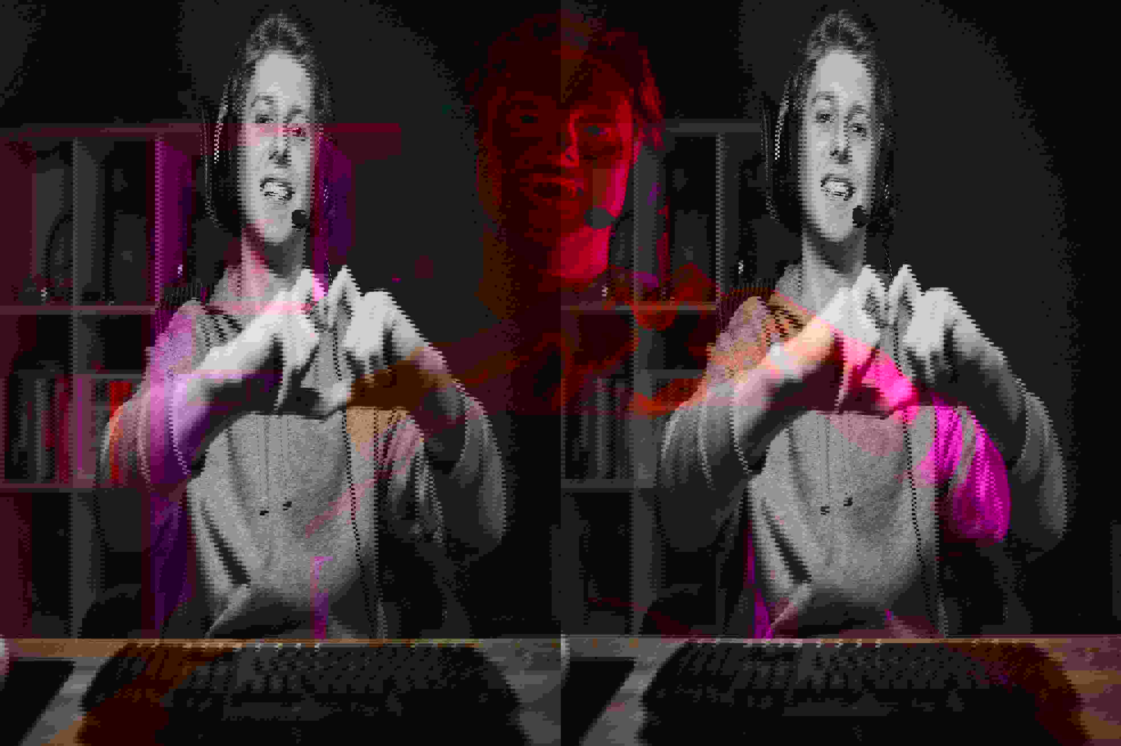 TP Russia employee working from home, wearing a headset and making a heart gesture with his hands in front of his computer.