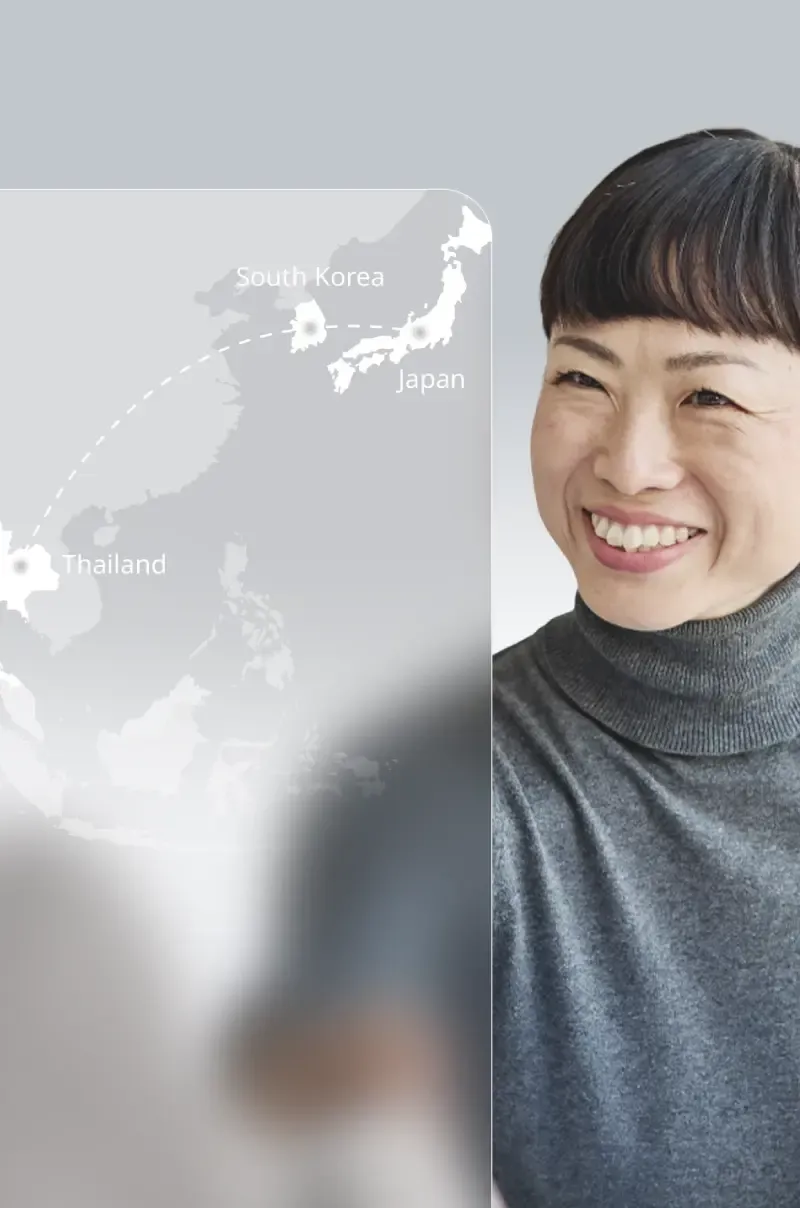 A middle-aged woman with short hair, smiling, is looking at the map.