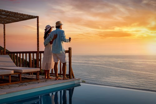 Couple watching the sunset on a hotel deck during a trip