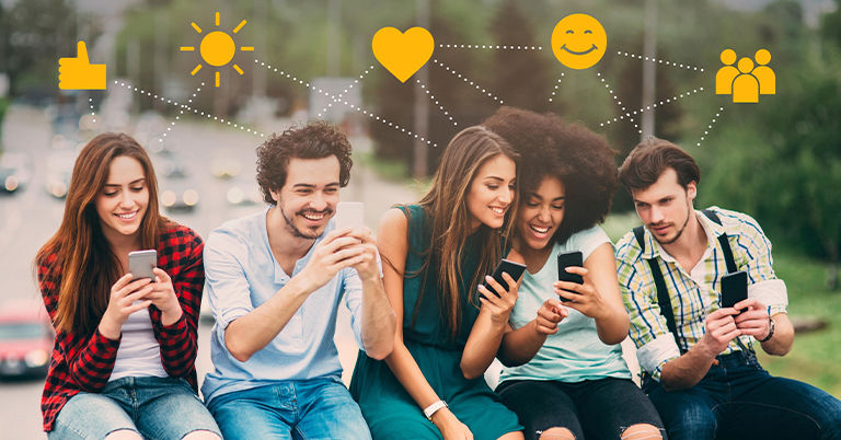 Five young adults sit outdoors, each focused on their smartphones, sharing digital moments together. Above them, icons like hearts, likes, and smiley faces float, symbolizing social media connection and emotion.
