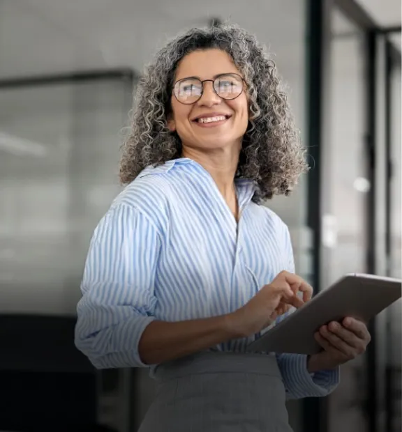 Woman in a office with a tablet in her hand