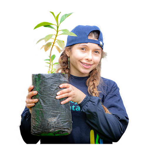 a young person wearing a backward cap holds a potted plant, smiling warmly. the plant is in a black bag, suggesting a gardening or environmental setting.