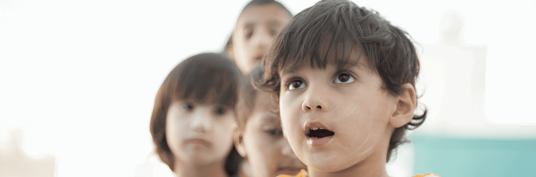 Child with a hopeful look, representing PR on supporting educational programs for over 17,000 children in the United States.