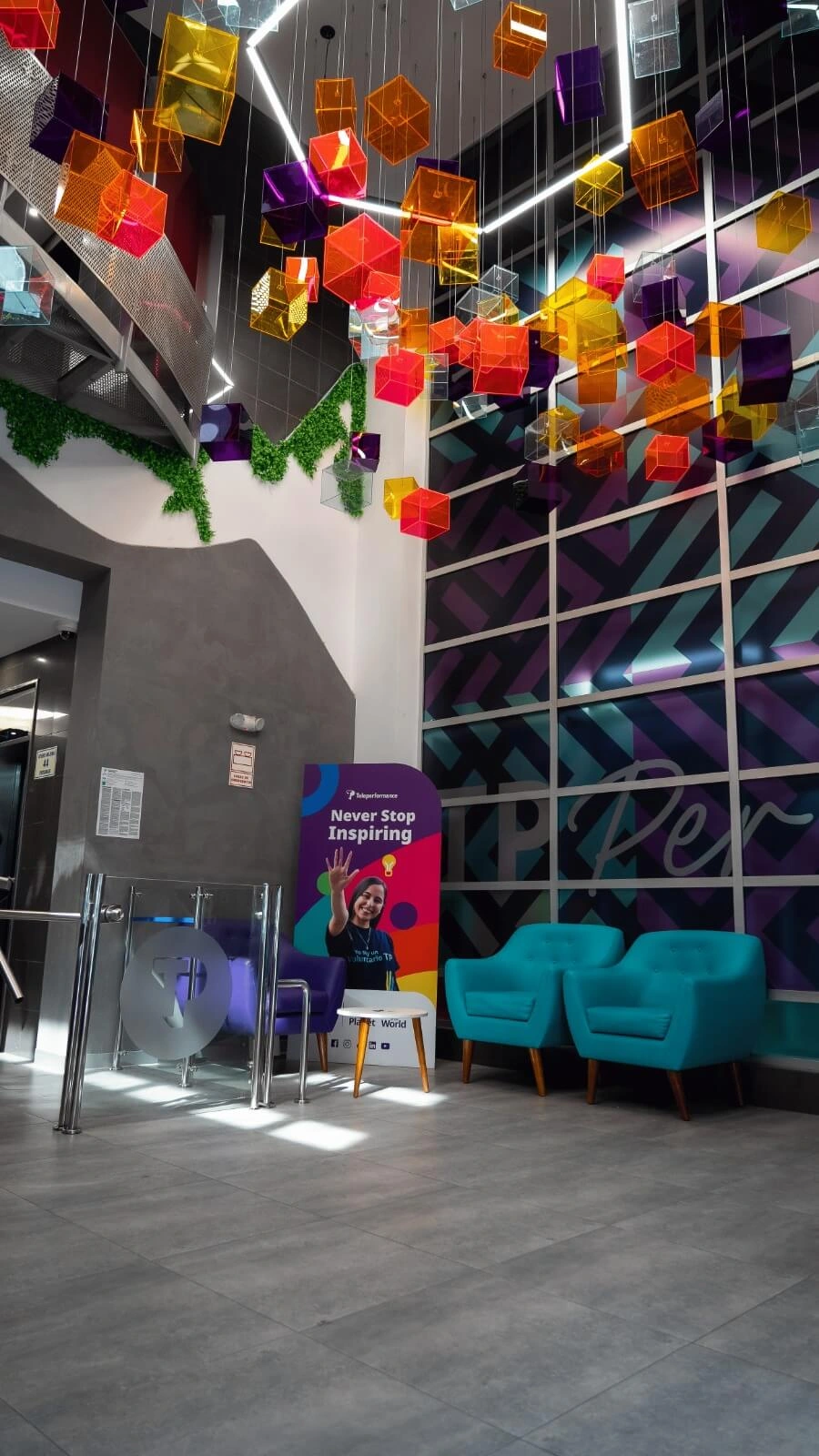 TP reception with two blue armchairs and orange squares in the ceiling. 