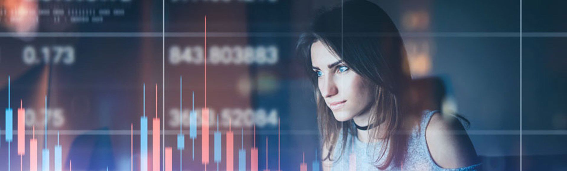Young woman analyzing stock market data on a digital screen, representing financial insight and technology.