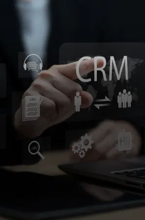 CRM dashboard icons over a laptop, showing customer data and workflow integration.