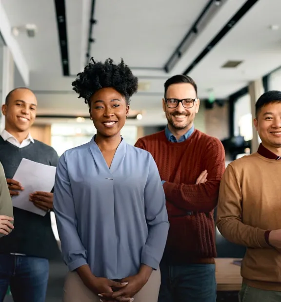 Smiling business people in a modern office staring the camera for a picture