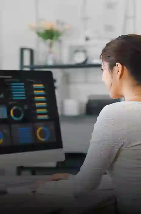 Woman analyzing business dashboards on a computer at TP office.