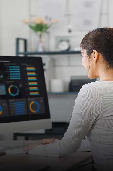 Woman analyzing business dashboards on a computer at TP office. Woman analyzing business dashboards on a computer at TP office.