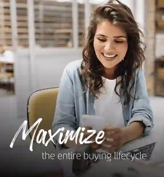 Woman smiling while looking at her phone at the office