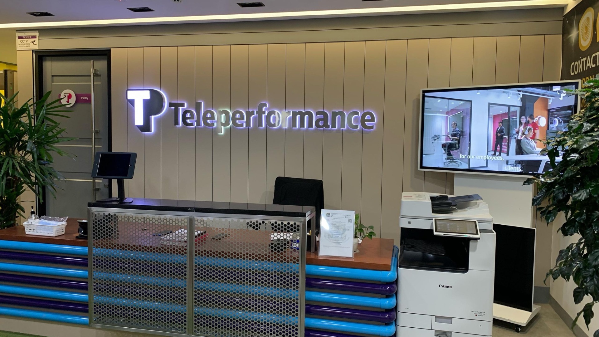 TP reception desk with illuminated logo and monitor display