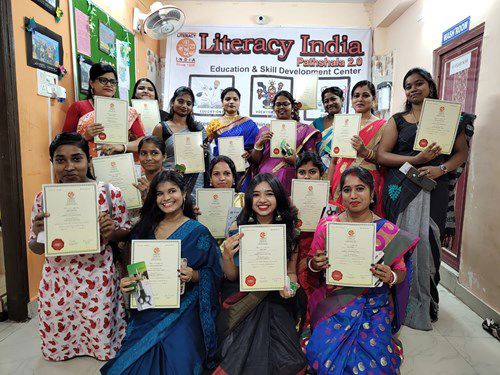 Diverse group of Indian women showing their certificates to the camera Diverse group of Indian women showing their certificates to the camera
