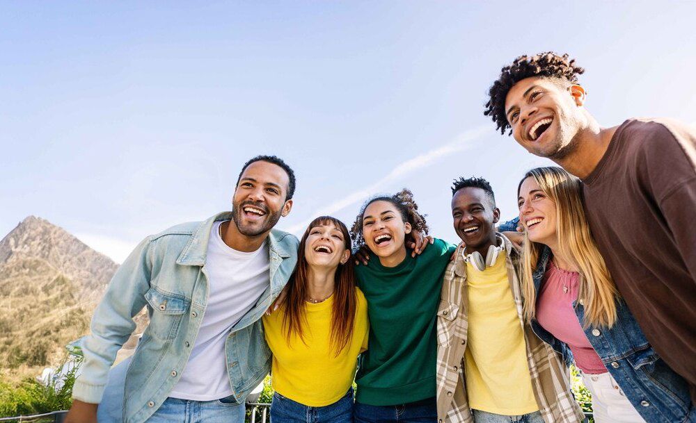 A diverse group of friends gathered together, sharing a joyful moment that conveys connection. A diverse group of friends gathered together, sharing a joyful moment that conveys connection.