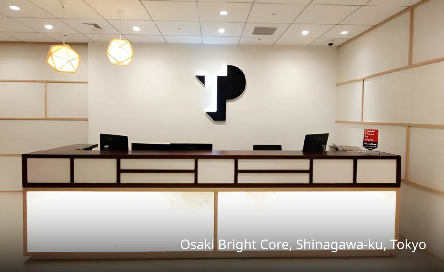 The reception desk in the workplace has the logo of TP.